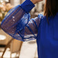 Top con scollo a V e maniche trasparenti con paillettes