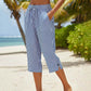 Pantaloni a zampa a righe in cotone e lino da donna con tasche