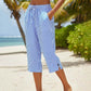Pantaloni a zampa a righe in cotone e lino da donna con tasche