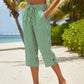 Pantaloni a zampa a righe in cotone e lino da donna con tasche