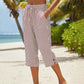 Pantaloni a zampa a righe in cotone e lino da donna con tasche