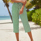 Pantaloni a zampa a righe in cotone e lino da donna con tasche